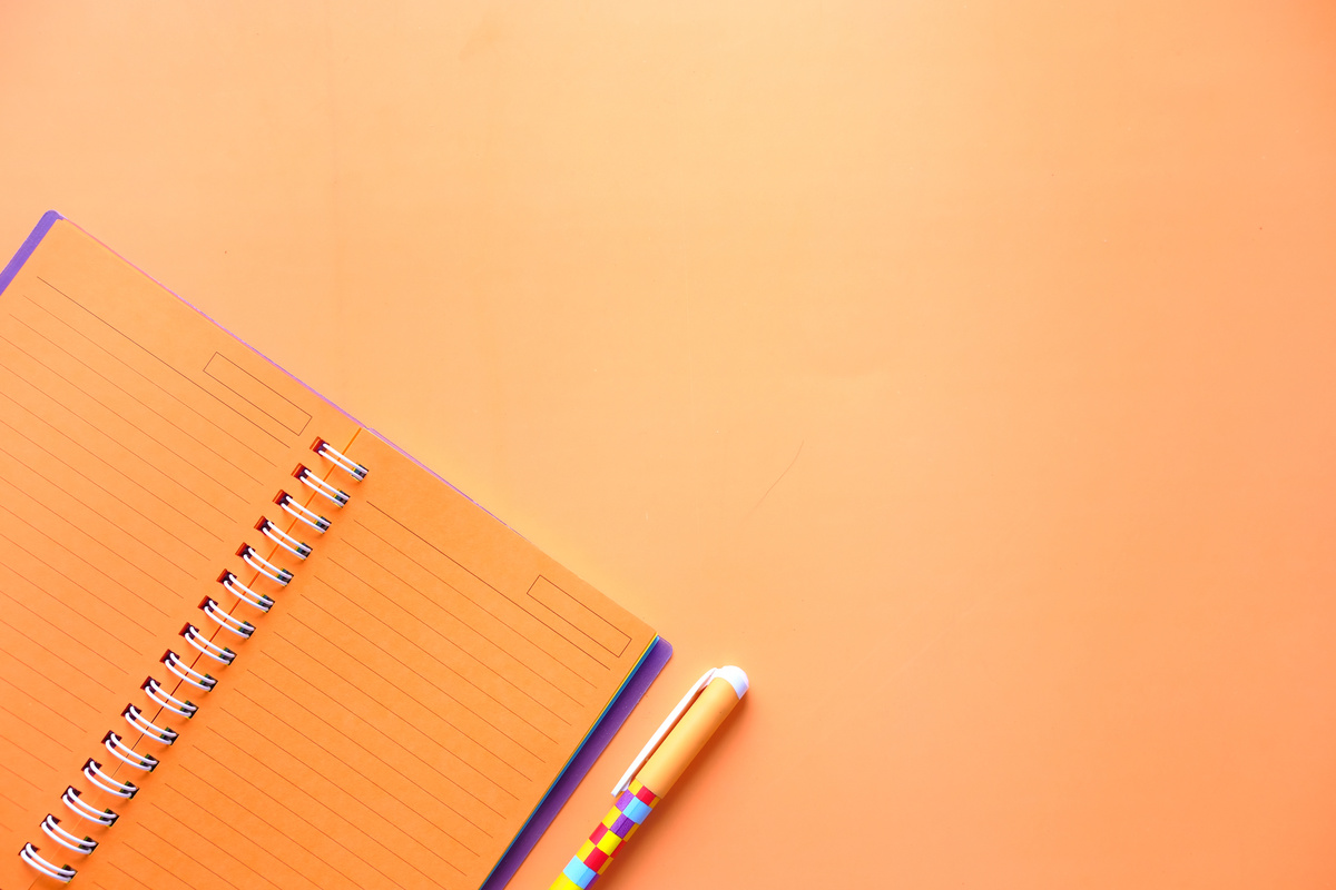 Orange Notebook and Pen Flatlay